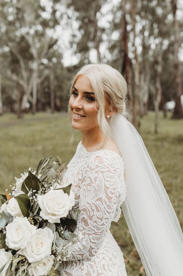 a bride in a white wedding dress with a veil