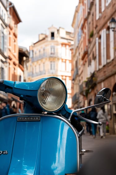 a blue scooter parked on a city street