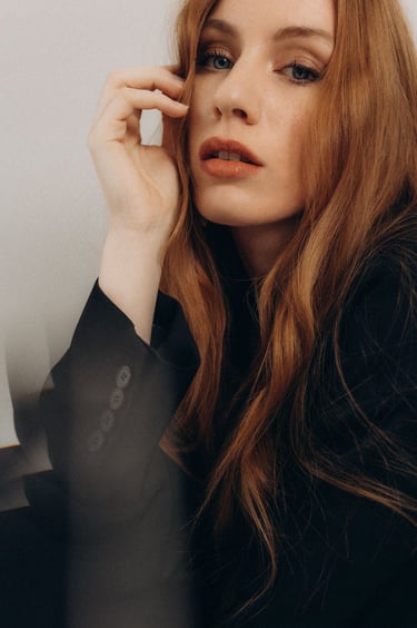 a woman with long hair and a black jacket