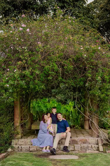 Family portrait during an adoption journey in Colombia, photographed outdoors as part of an adoption