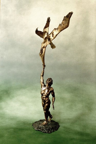 a bronze sculpture of a manreaching to touch a  bird's wing 