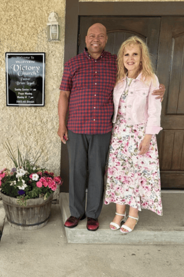 Pastors Brian and Alexis standing in front of Valleyview Victory Church.