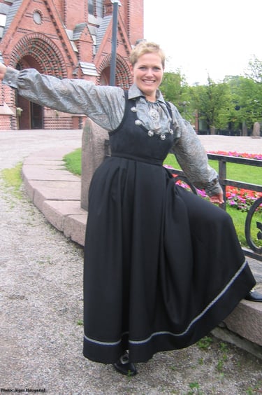 A woman in a black dress standing outside a church
