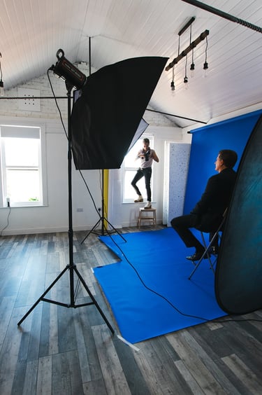 a man is taking a photo of himself in a studio