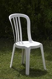 a white plastic chair with a white chair and a black chair