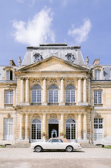 main entry at chateau de champlatreux with luxury car for the wedding
