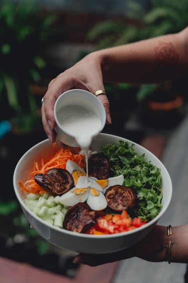 a person holding a sandwich with a sandwich on it