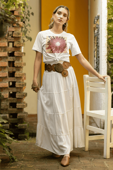 a woman in a long skirt wearing a white t shirt with the design Abstract Pink Daisy Light on a Pink 