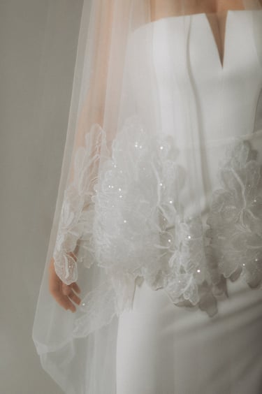 a woman in a white dress with a veil and veiled veil