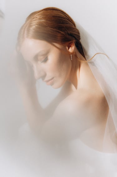 a woman in a wedding dress with veil and veil veil