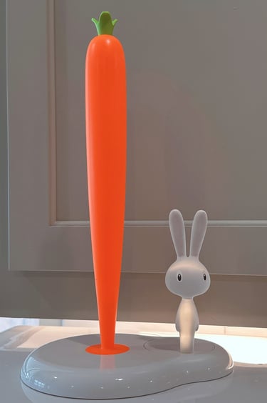 Modern white kitchen paper towel holder featuring a tall orange carrot and a cute bunny rabbit figure.
