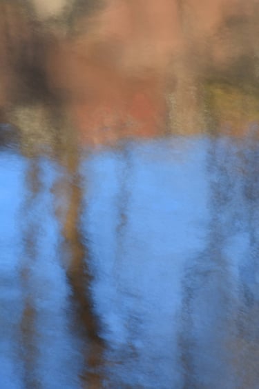 painterly image by a canal with trees reflections and
