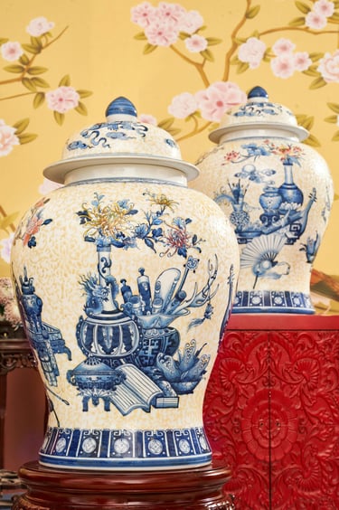 a pair of ornate oriental vases with a blue and white