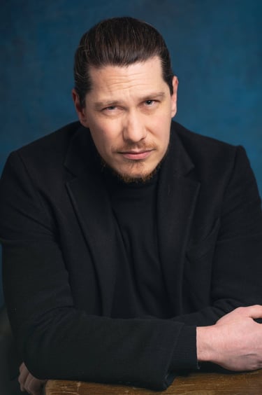 a man in a black suit and a black jacket