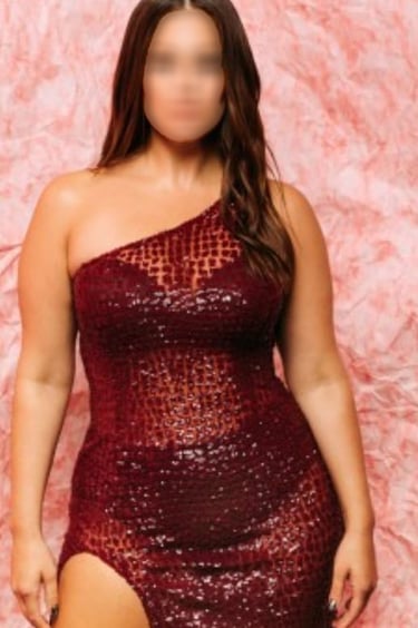 a woman in a red dress with a thigh high slit