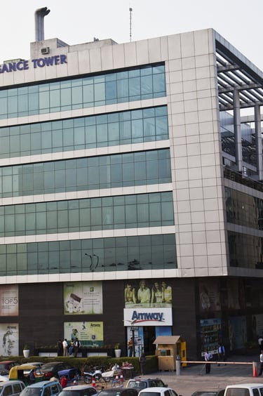 a large building with a lot of cars parked in front of it with elegance tower written on top