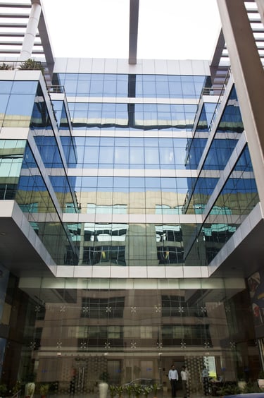 a building with a lot of windows and a car parked in front of it