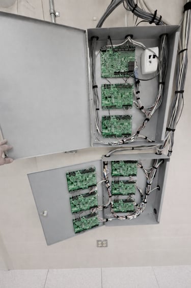 Open commercial access control cabinet showing door controller boards and wiring in an Ottawa facility.