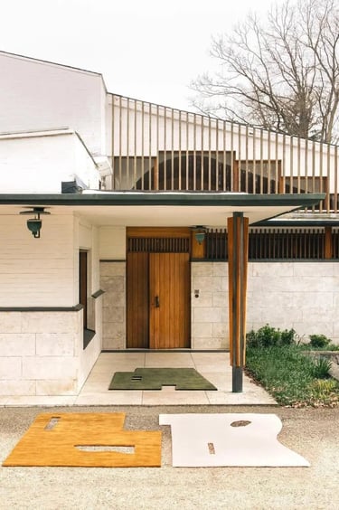 Alvar Aalto building exterior with clean white walls, wooden entrance and simple Nordic modern desig