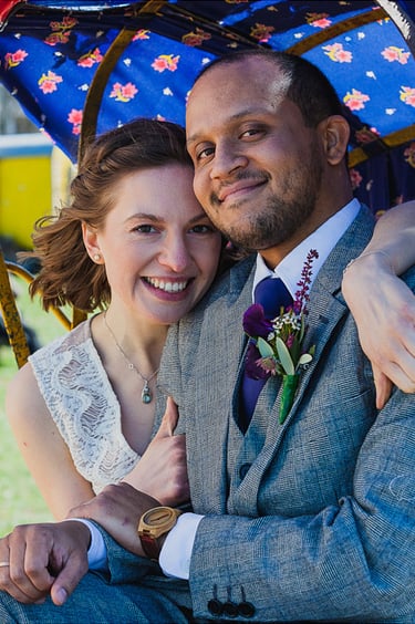 Portrait of bride and groom sitting in a rickshaw.