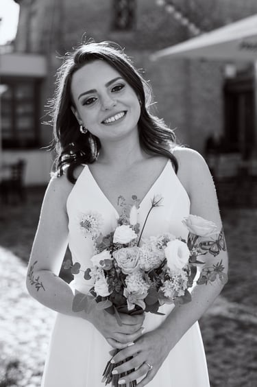 A black and white portrait of a bride holding flowers.