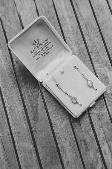 Earrings in a box laid out on a table.