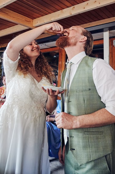 Bride feeding grapes to groom.