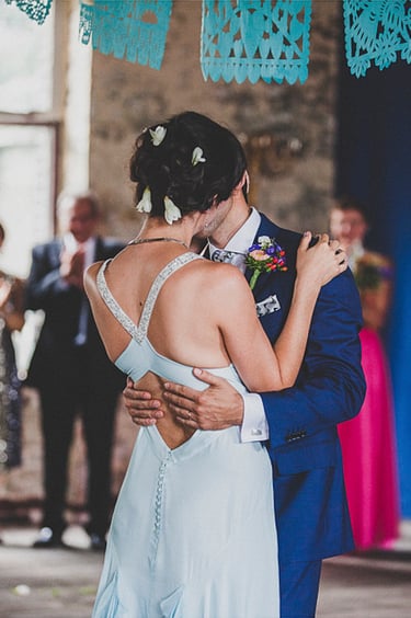Bride and groom kiss at a wedding ceremony.
