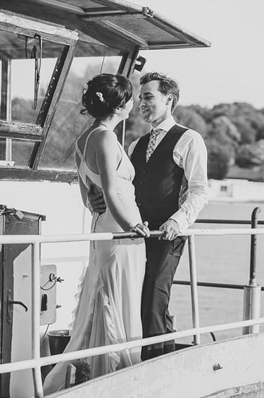 A bride and groom on a boat.