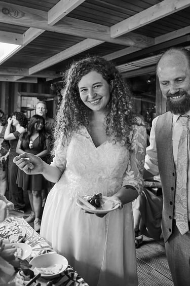 Bride and groom with a plate of cheese with grapes.