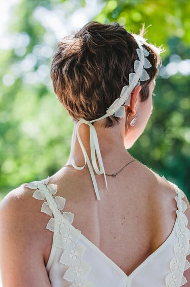 Bride with short hair photographed from the back.