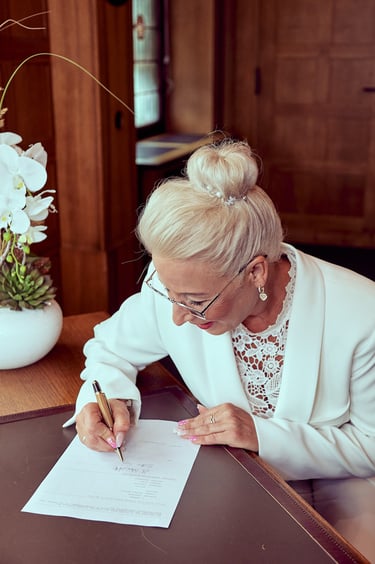 Bride signing documents.