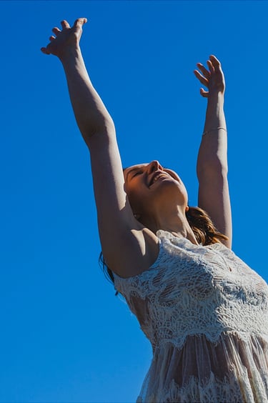Bride stretching her hands to the sky.