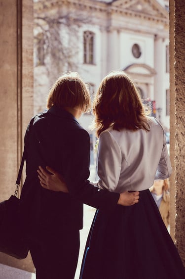 Two brides looking in the distance.