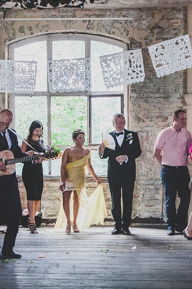 Wedding guests at the old carpet factory during the ceremony.