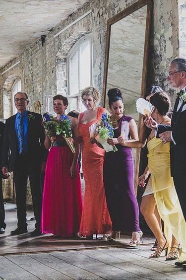 Wedding guests in colourful clothes at a reception.