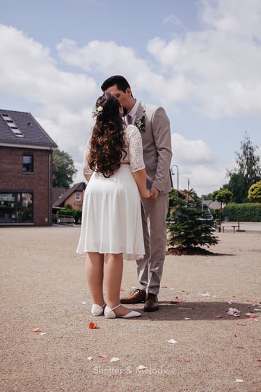 Bride and groom kissing. 