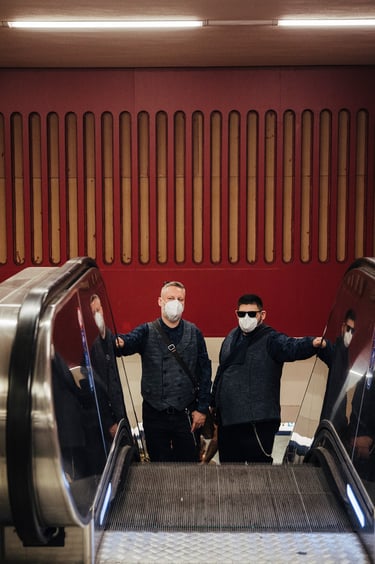Grooms with masks using the escalator.