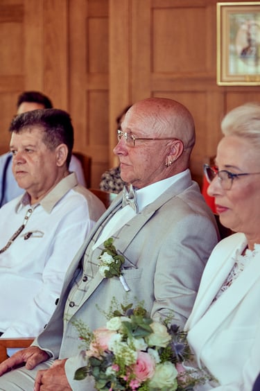 Groom sitting during a civil ceremony.