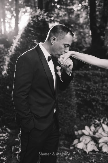 Groom kissing the brides hand.