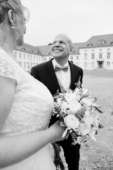 Groom staring at the bride with a smile.