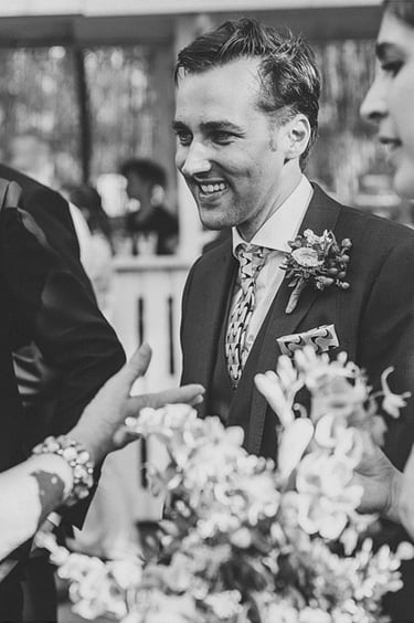 The groom smiling.