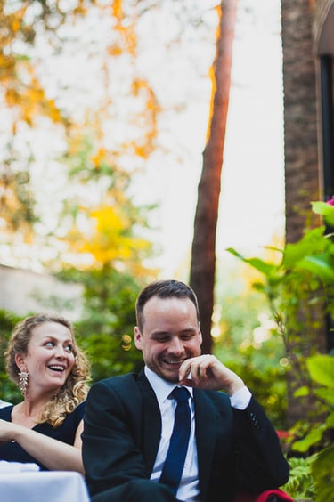 Wedding guest laughing during reception.