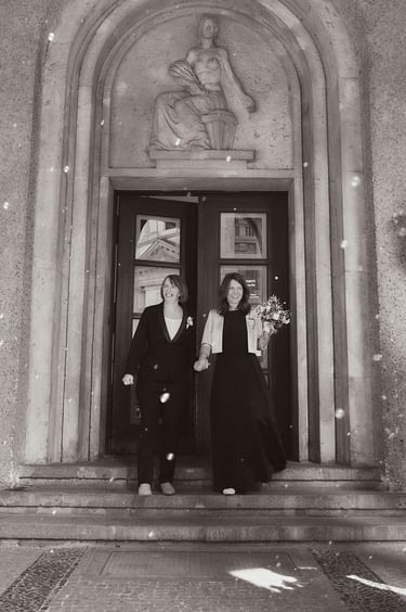 LGBTQ+ couple exiting Standesamt Mitte.