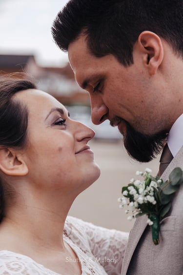 Bride and groom staring into each other's eyes.
