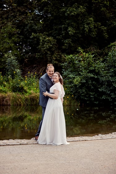 Bride and groom standing next to a pond in Rudolph-Wilde-Park.