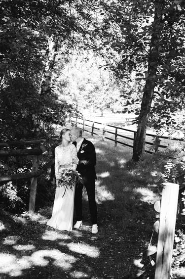 Bride and groom kissing in the countryside.