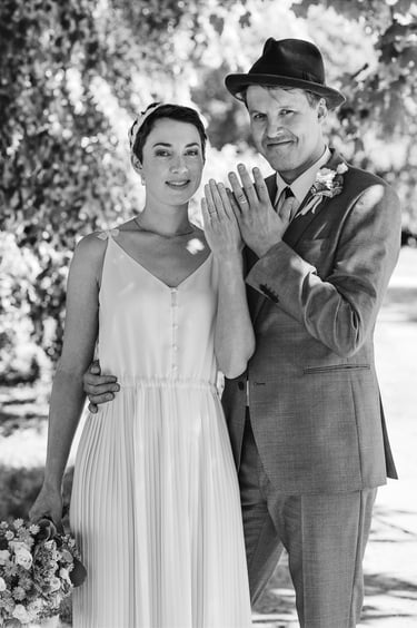 Bride and groom showing off their wedding bands.