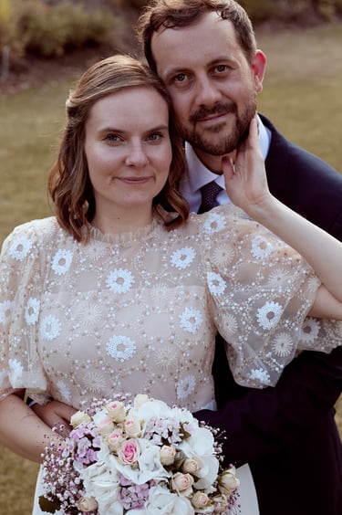 Bride and groom looking directly into the camera.