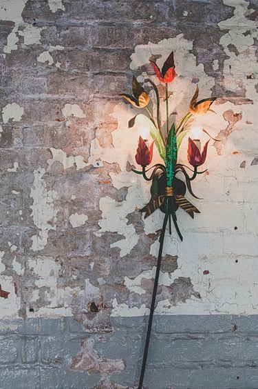 A wall lamp with metal tulips.